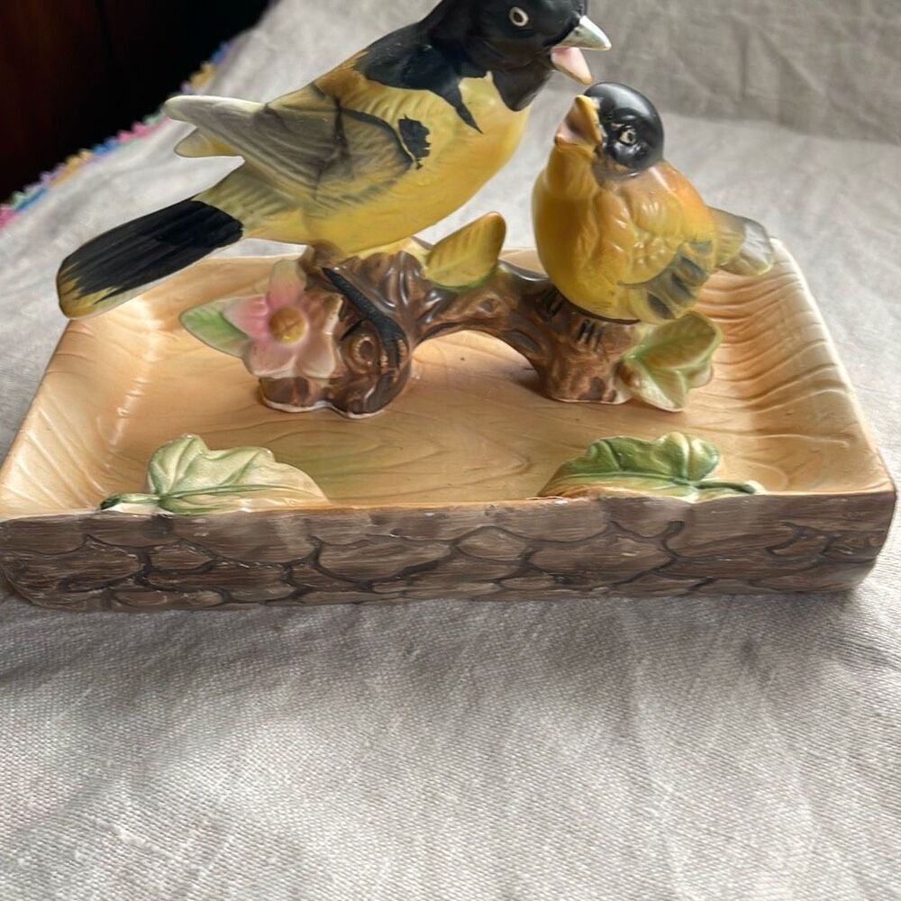 Midcentury Tilso Japan orioles perched on beach like base.